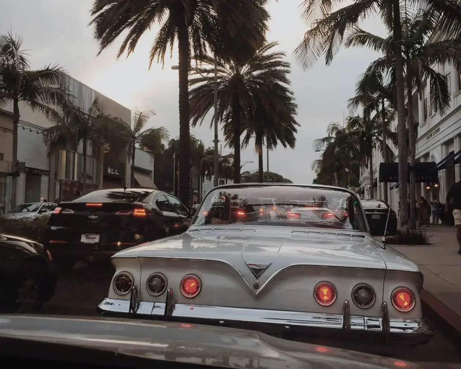 An image of cars on a traffic jammed street lined with palm trees, showing the difficulty of trying to be on time for an in person appointment in a busy city