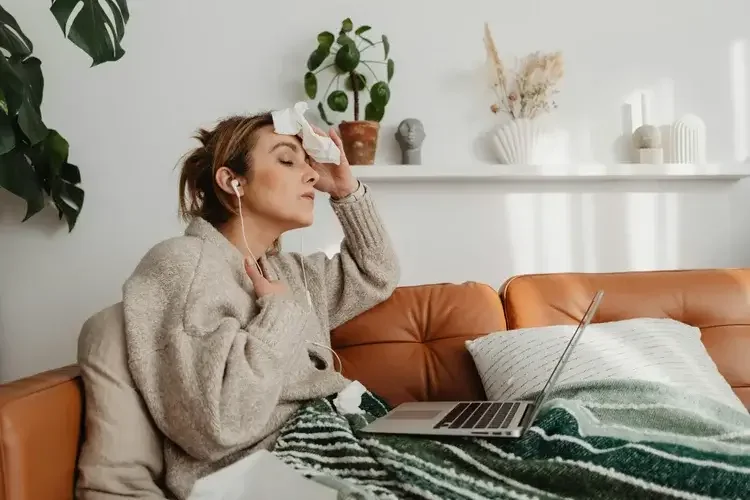 Photo of a woman who is struggling with a hot flash due to perimenopause, representing the difficulties women face during menopause. 98004 | 98201 | 98032 |
