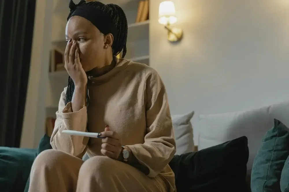 Image of a woman holding a pregnancy test. Get help in infertility therapy. As a Los Angeles infertility therapist, I know infertility depression is real. Call today to start infertility counseling in Manhattan Beach, CA 90274.  90274 | 90254 | 90405