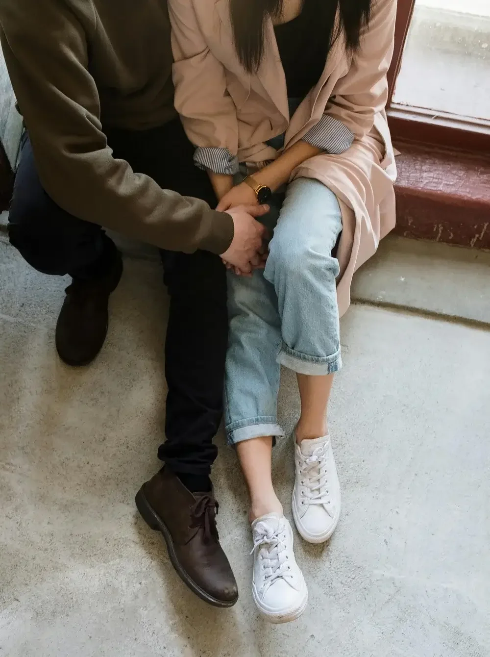 A couple sitting and holding hands representing struggles with infertility. 90266 | 90015 | 90402