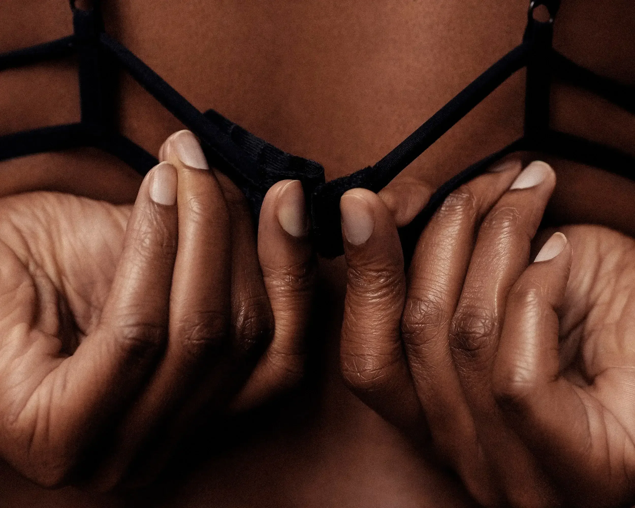 Image of a woman unhooking her bra. Representing the increase of intimacy that can be had after starting sex counseling & individual therapy for relationship issues in Los Angeles & Manhattan Beach, CA. An intimacy therapist can help your sex life.