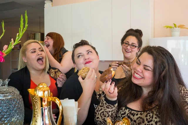 A group of women in diverse bodies eating donuts, representing the peace that can come from ditching diet culture and working with a body image therapist in Los Angeles. 91436 | 90027 | 91105