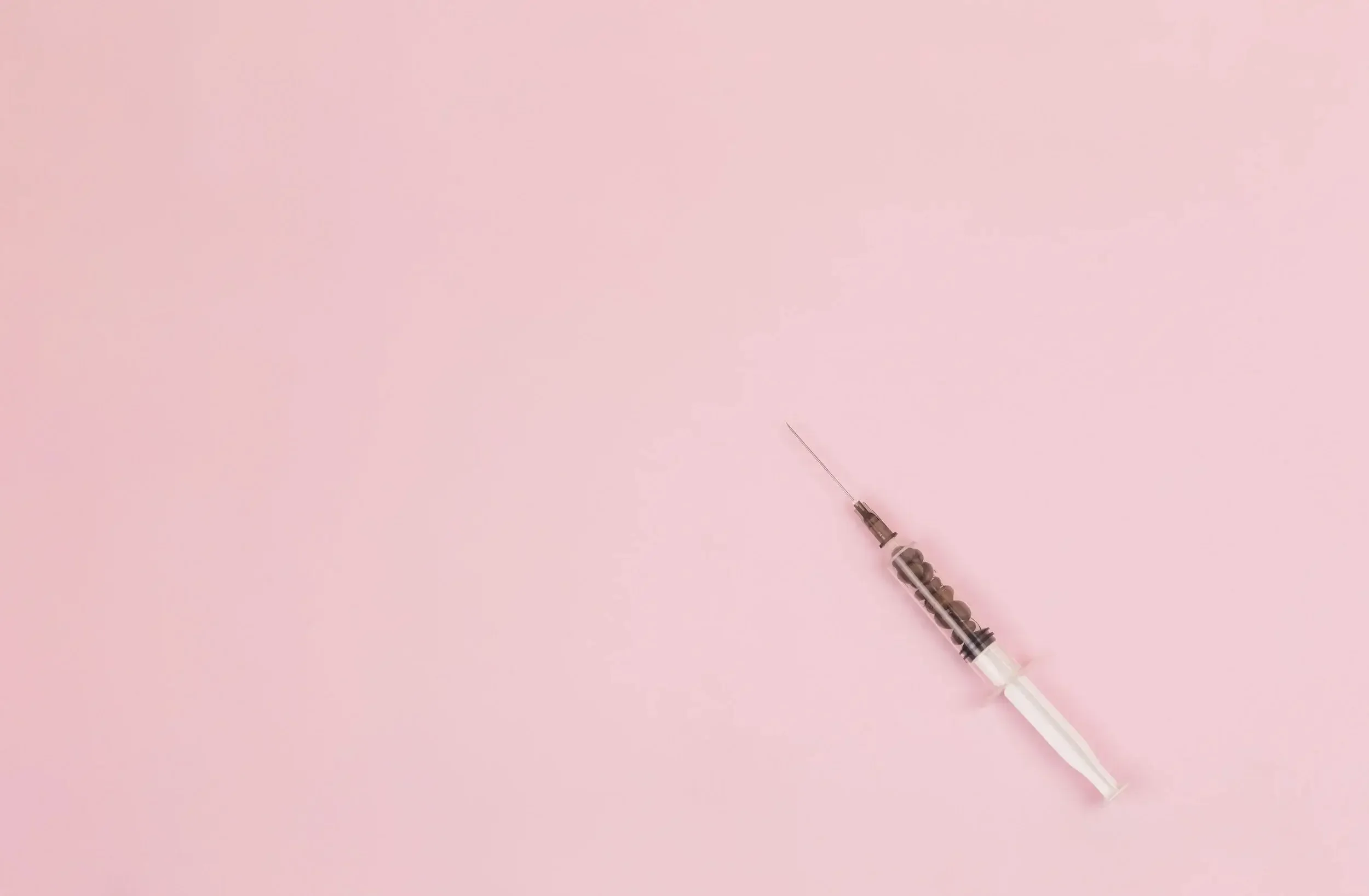 A photo of a syringe illustrating the side effects of infertility treatment. An infertility therapist in Los Angeles can help you cope as a part of infertility therapy in Los Angeles.