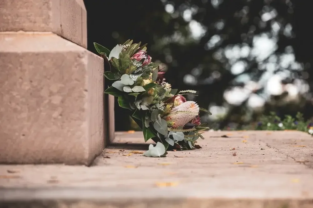 Image of a floral arrangement at a gravesite. If you are grieving the loss of a loved one, I can help. I'm a grief counselor in Los Angeles. 90266 | 90277 | 90402