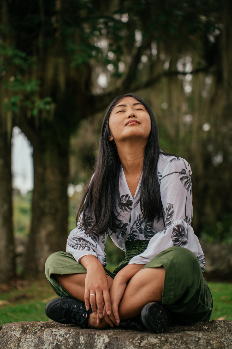 Woman in nature relaxing as a way to decompress. If you'd like help with being avoidant therapy in LA is available. 90027 | 90277 | 90401