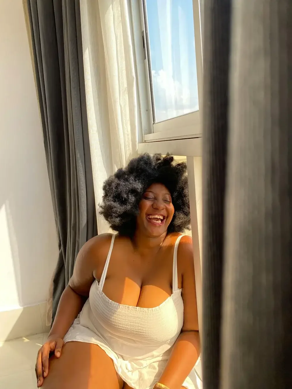 A plus size woman laughing, representing the happiness after working on body image therapy in Spokane, Tacoma and Vancouver, WA.