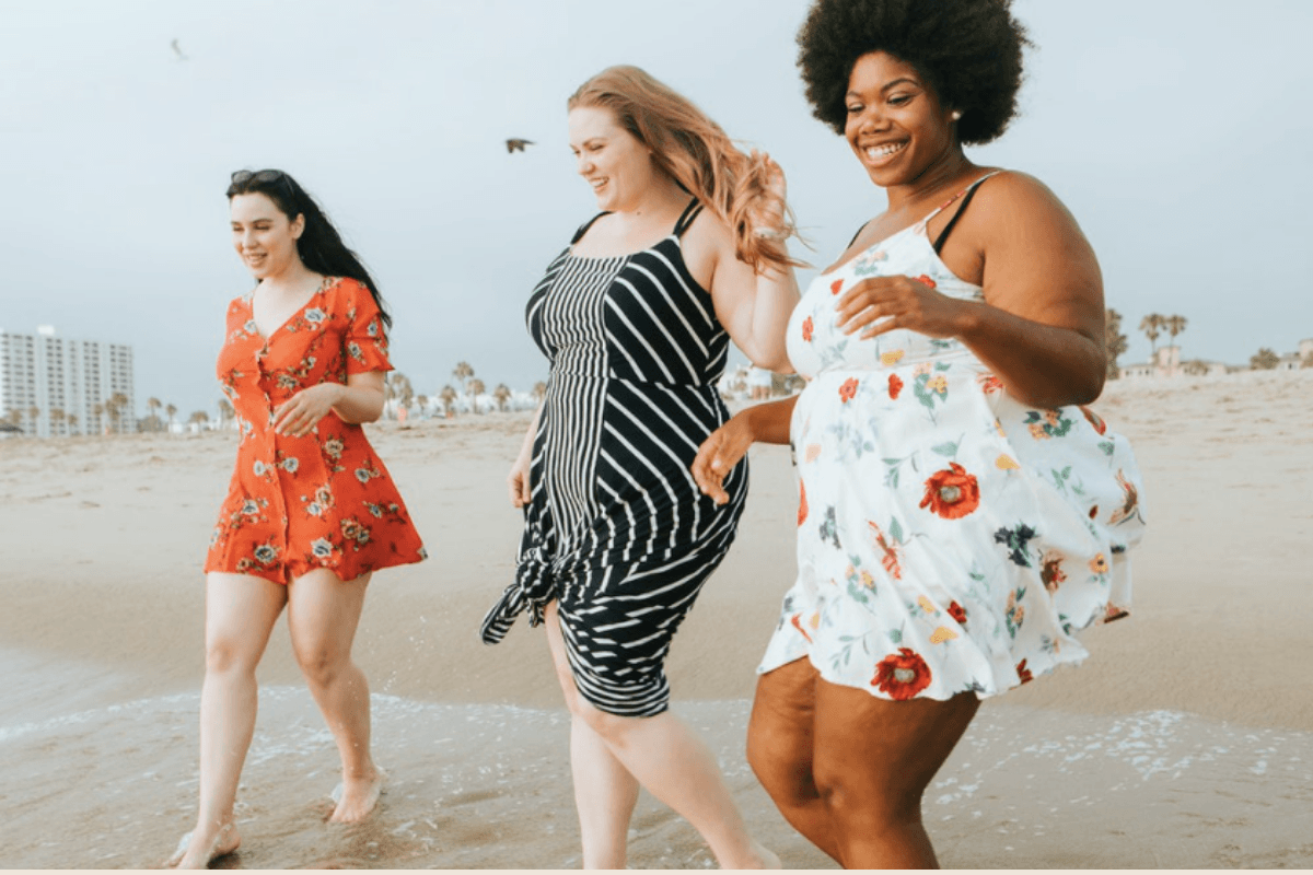 3 women running joyfully on the beach. Being present in our lives and not being distracted by bad body image thoughts is possible. Talk to a weight inclusive therapist in LA. 90274 | 90402 | 90027