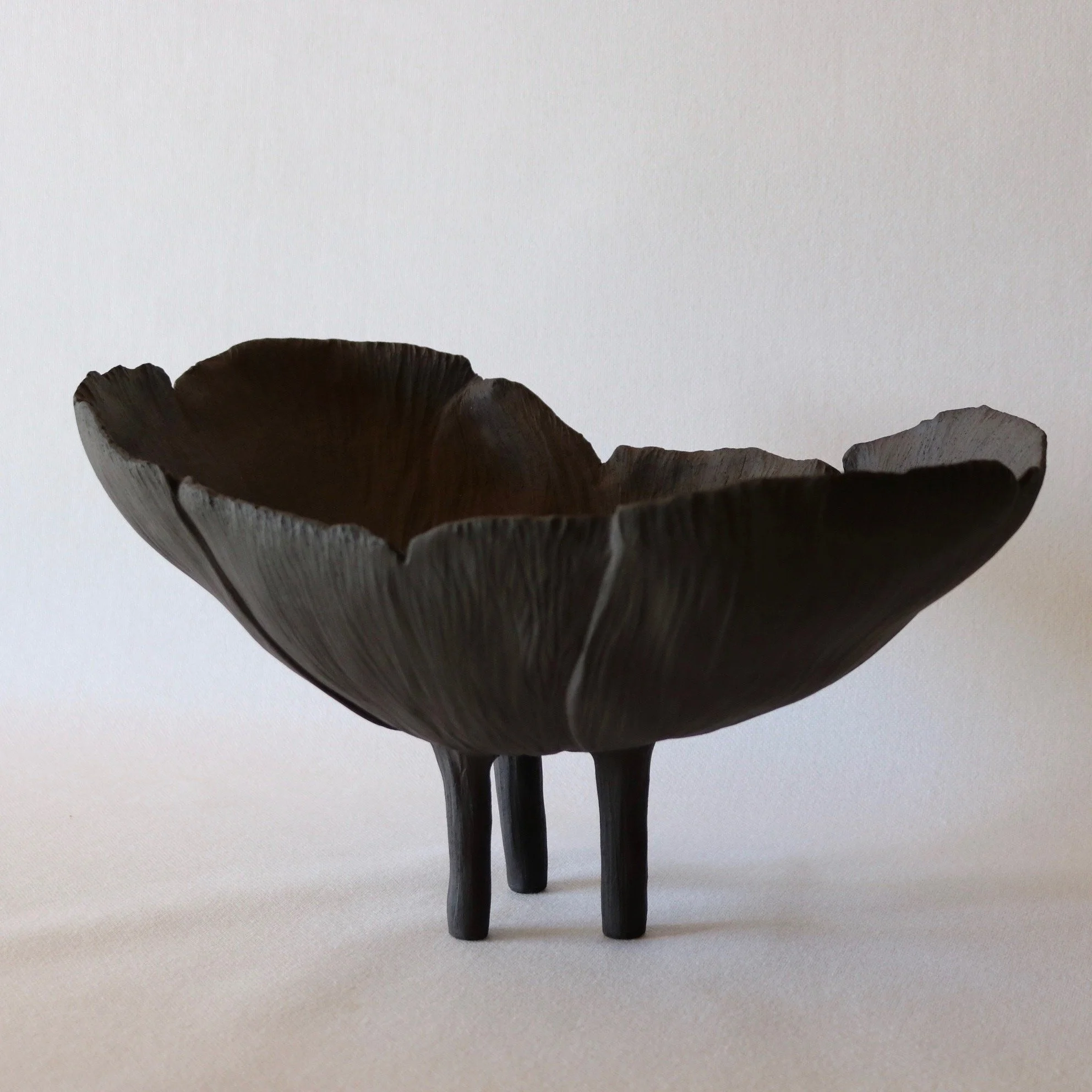 A large handsculpted black stoneware ceramic bowl. The form is created to represent the beauty of the night flowering evening primrose. Handcrafted in New Zealand.