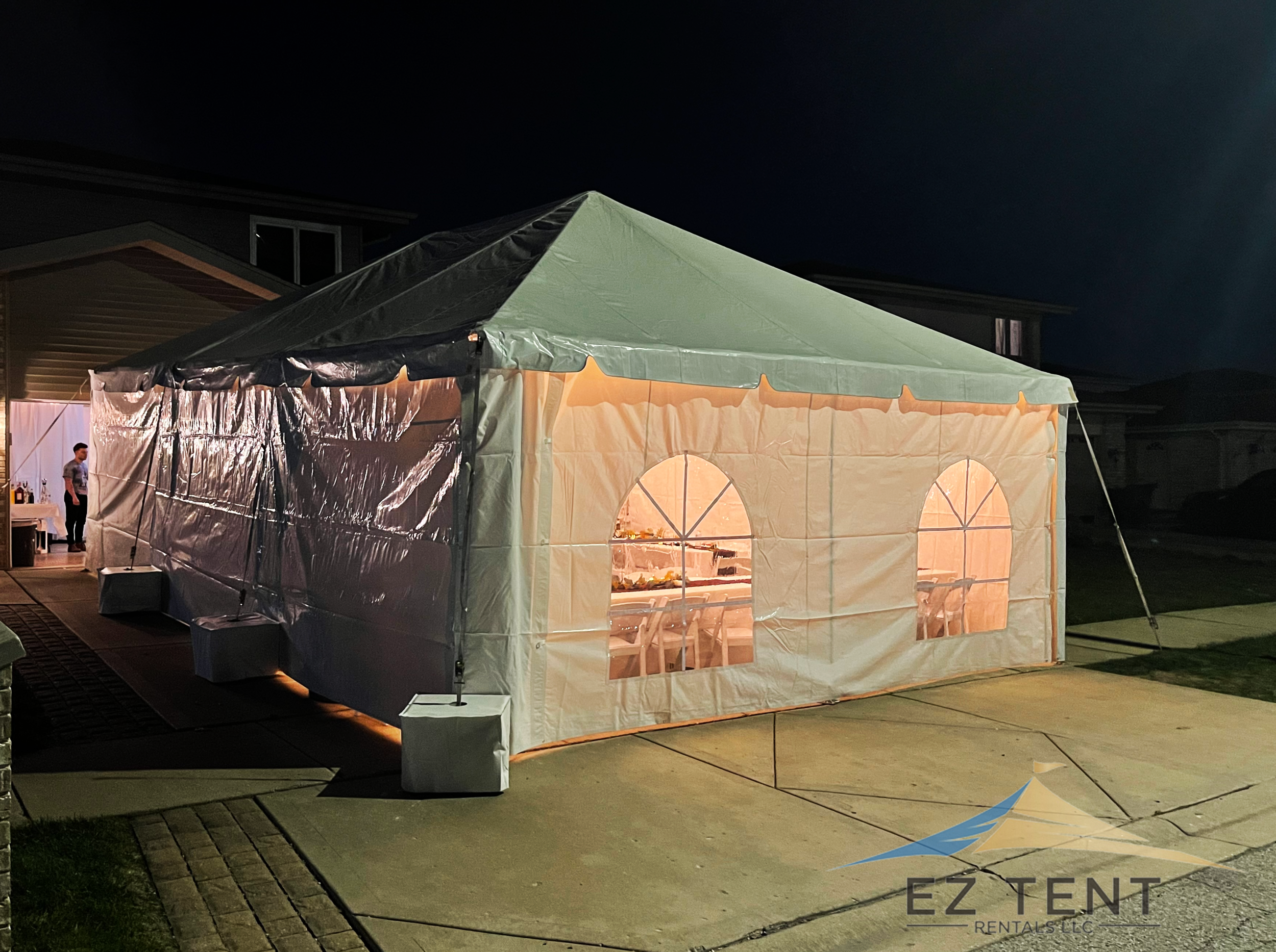 Lighted tent set up in a driveway