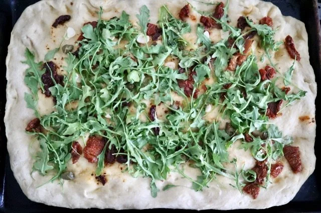 Flatbread with Arugula, Sun Dried Tomatoes and Capers