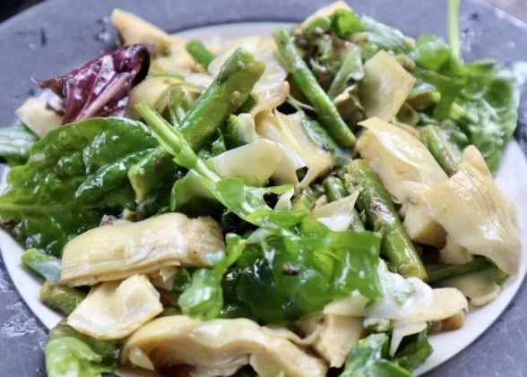 Salad with Artichokes, Aspragus, and salad greens on plate 