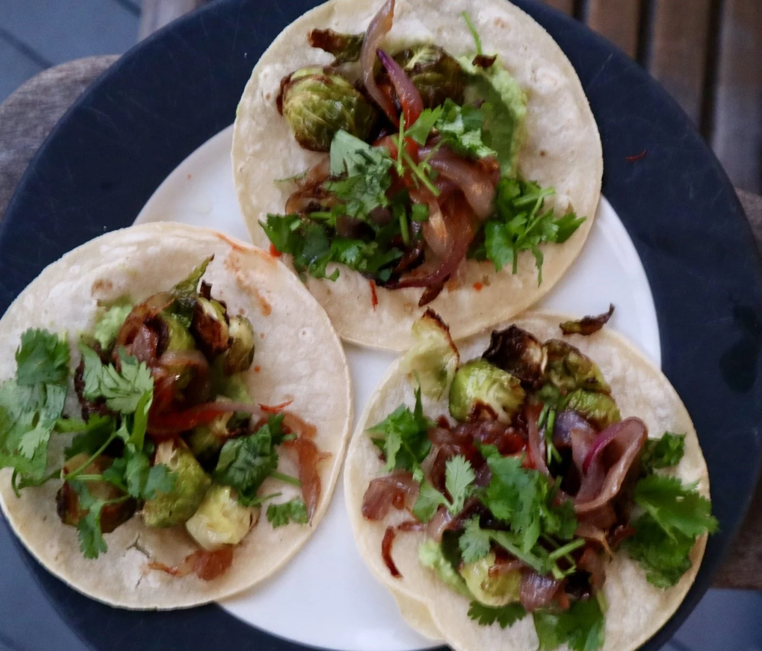 Three Brussel sprout tacos on a platter