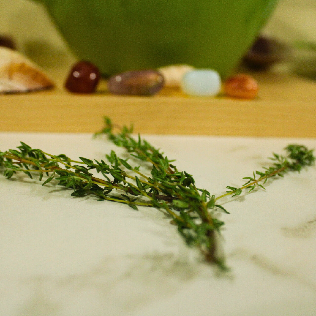 Fresh thyme herb on a kitchen counter with colorful gemstones