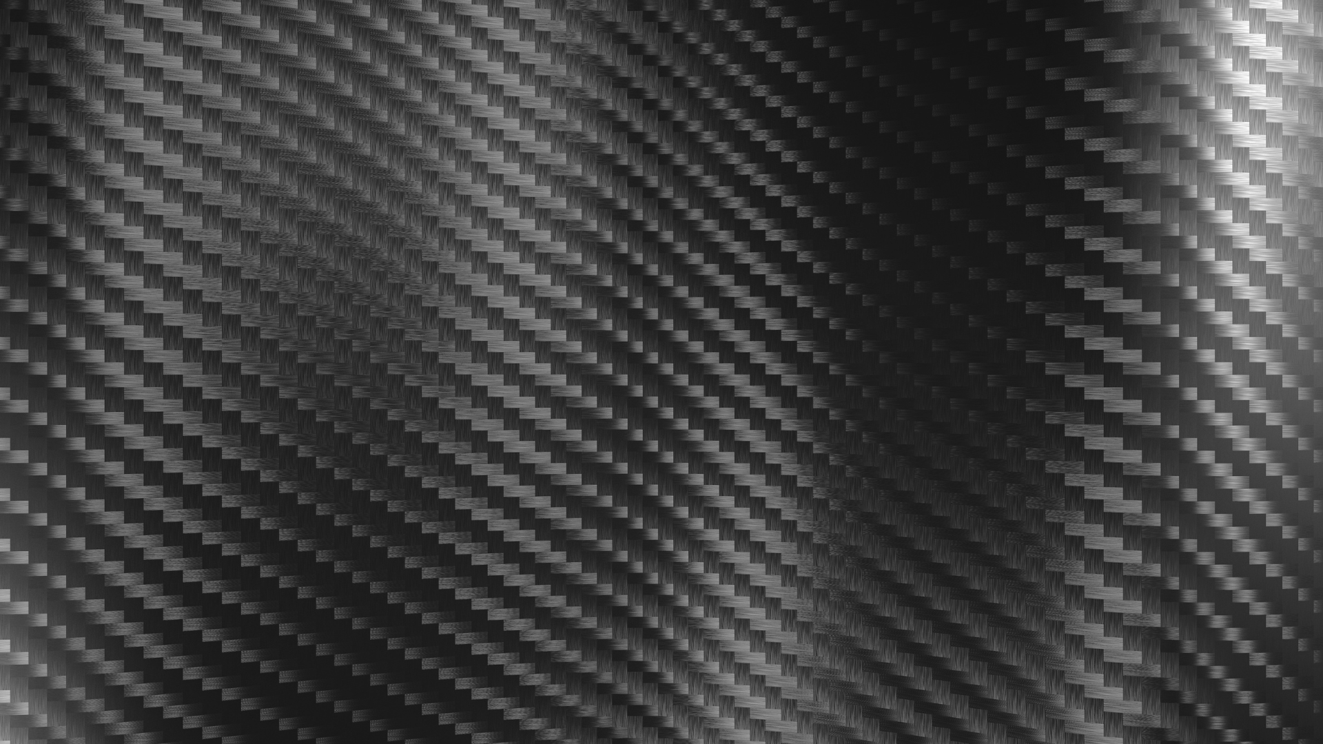Close-up of a carbon fiber surface with a diagonal checkerboard pattern, black and gray metallic appearance.