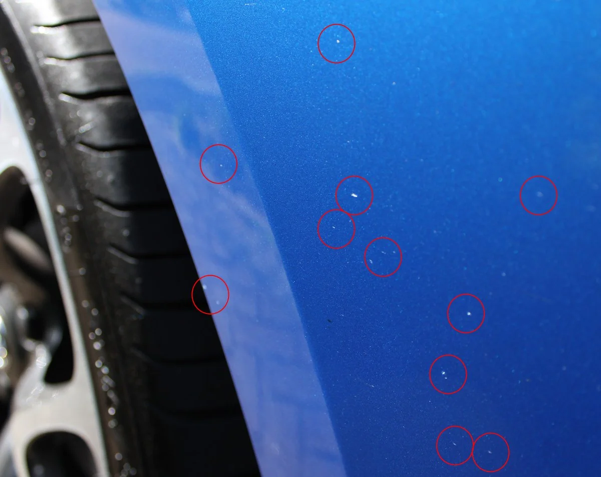 Car bonnet rock chip damage circled showing need for paint protection film at Highlands Auto Studio Mittagong