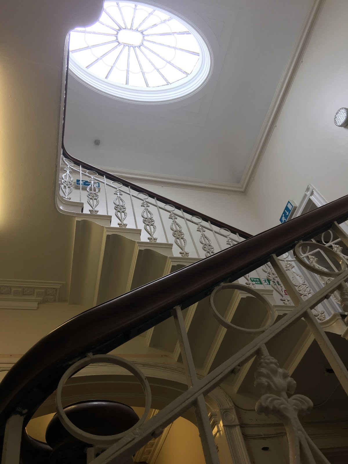 The Plex is a grade 2*  listed building in St John’s Wakefield on Margaret street. This photo shows the landing with a large oval glass fan light and white ornate balcony.