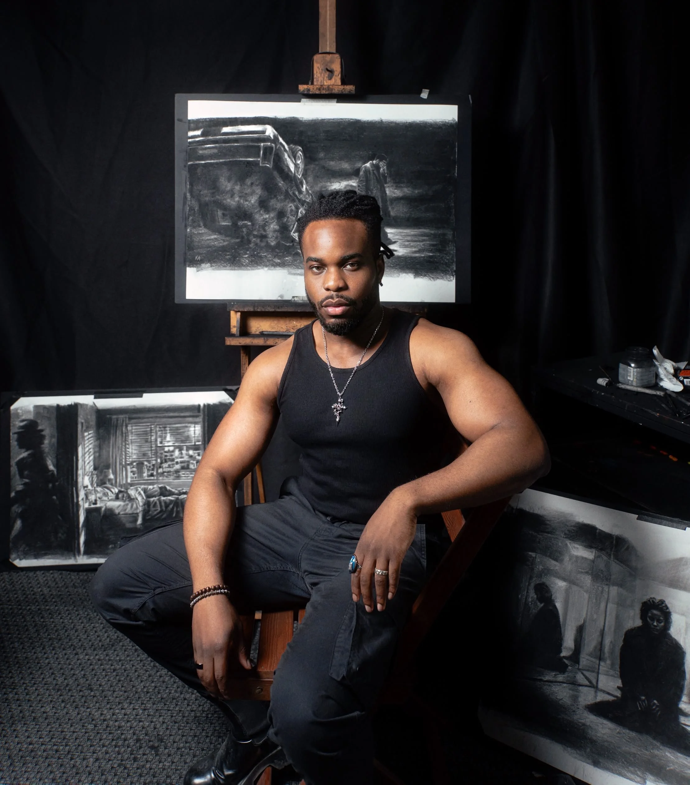 Contemporary artist Victor Ajayi in his Stockholm studio among his charcoal drawings.
