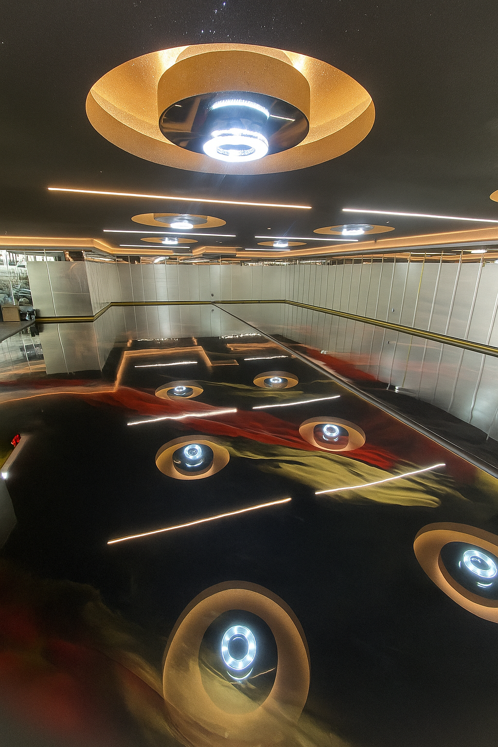 Completed metallic epoxy garage floor with a high-gloss finish, showcasing flowing gold  and red tones for a sleek, modern look