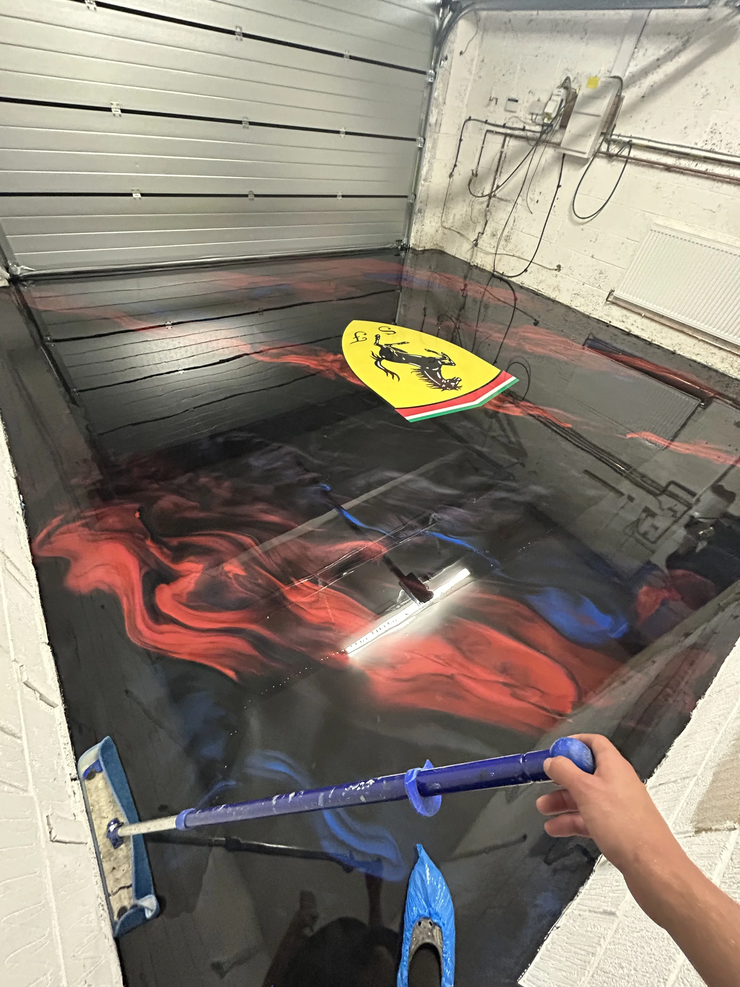 resin epoxy flooring with Ferrari logo