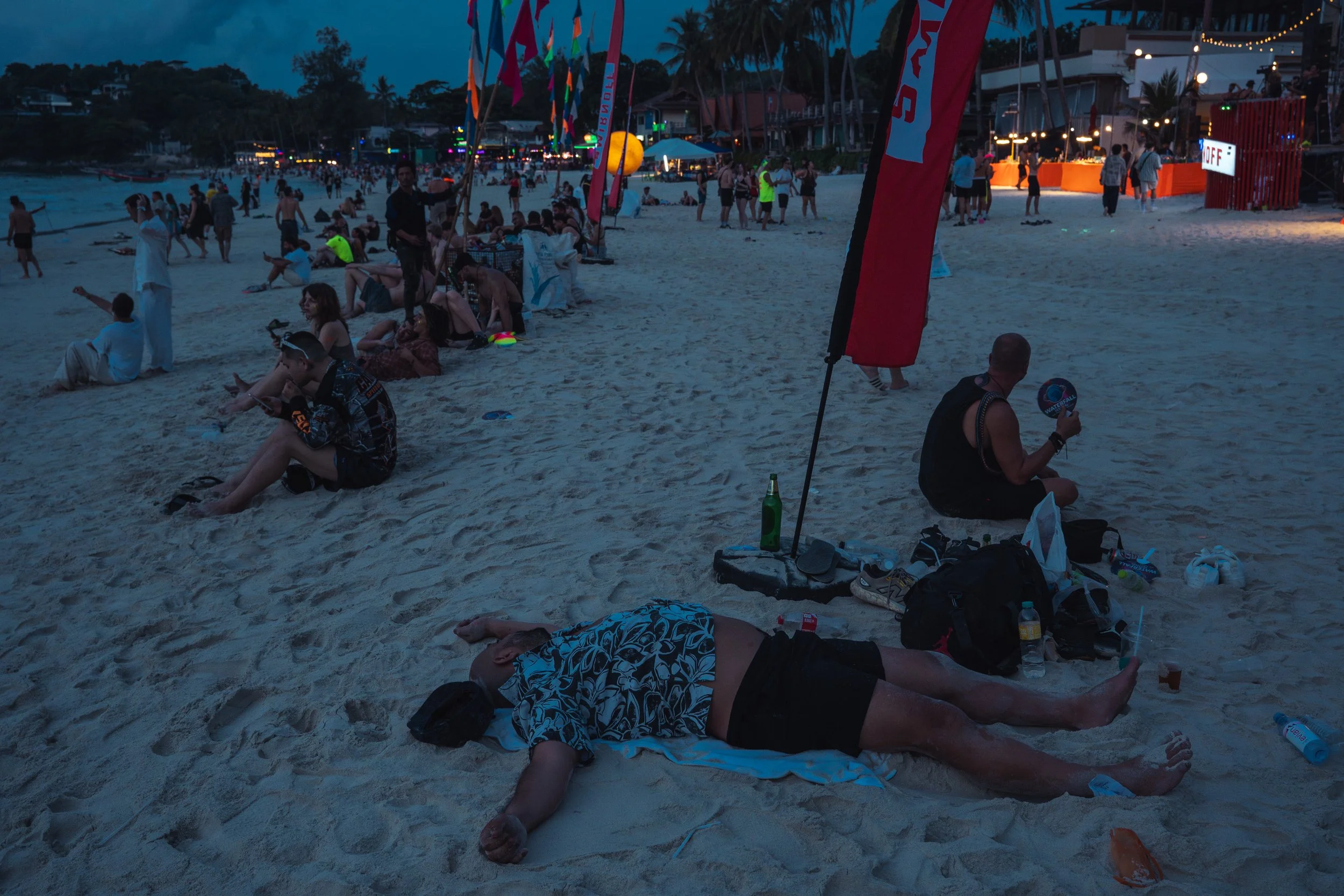 As dawn breaks, some revellers choose to sleep on the beach.