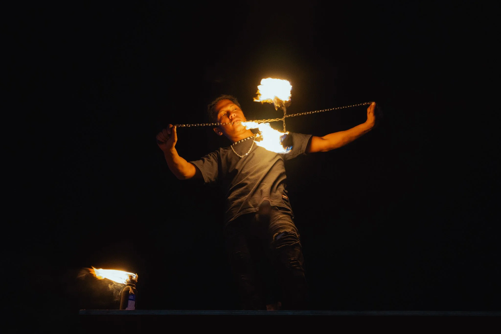 A fire juggler entertains the crowds.