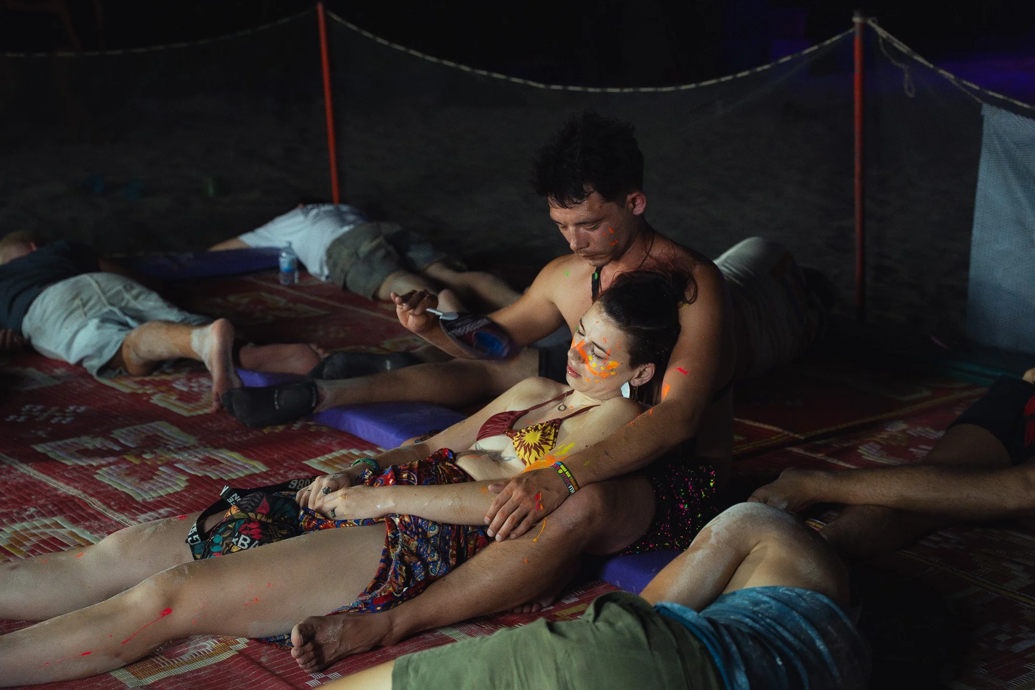 A young man fans a comatose woman.