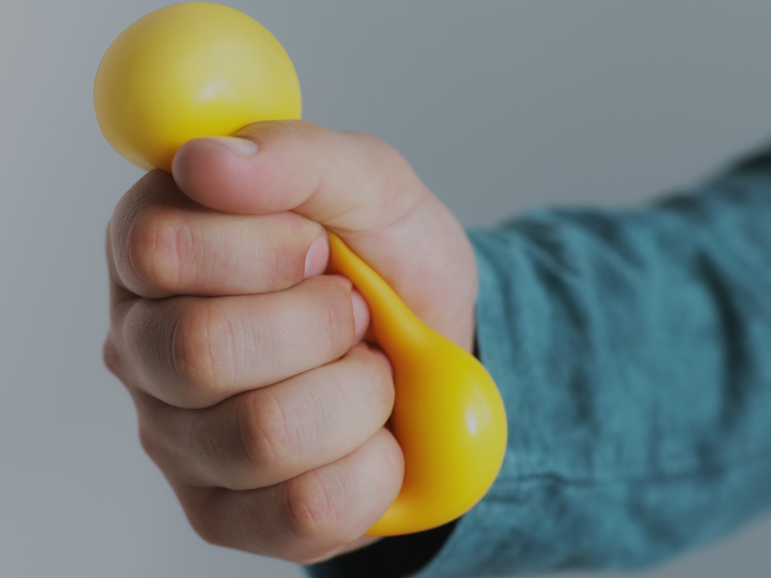 hand squeeze yellow stress ball