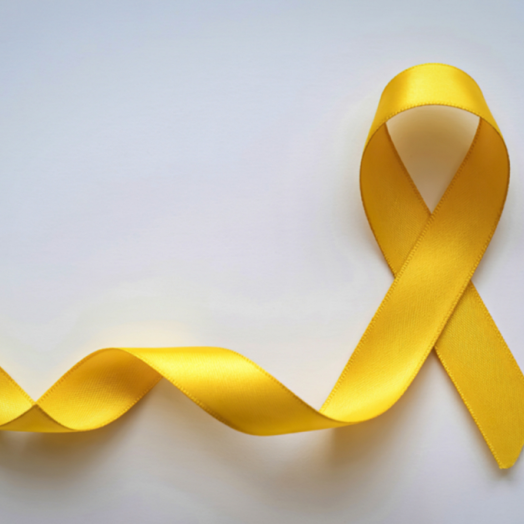A looped yellow ribbon to the right behind a white background