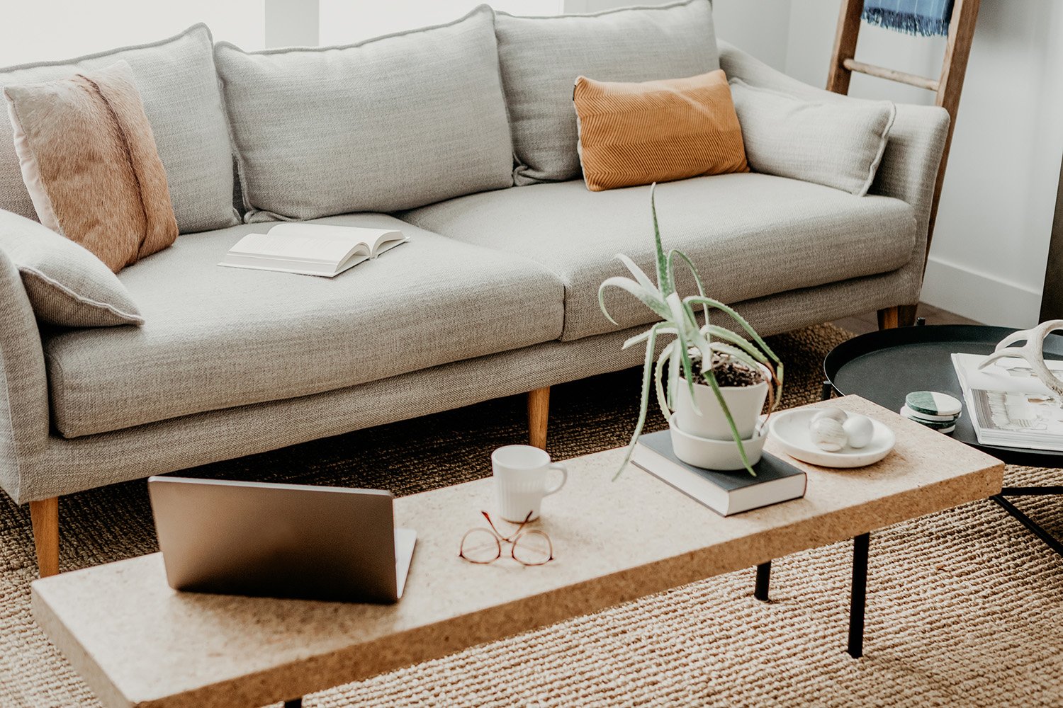 Living room with gray fabric and clean wood table