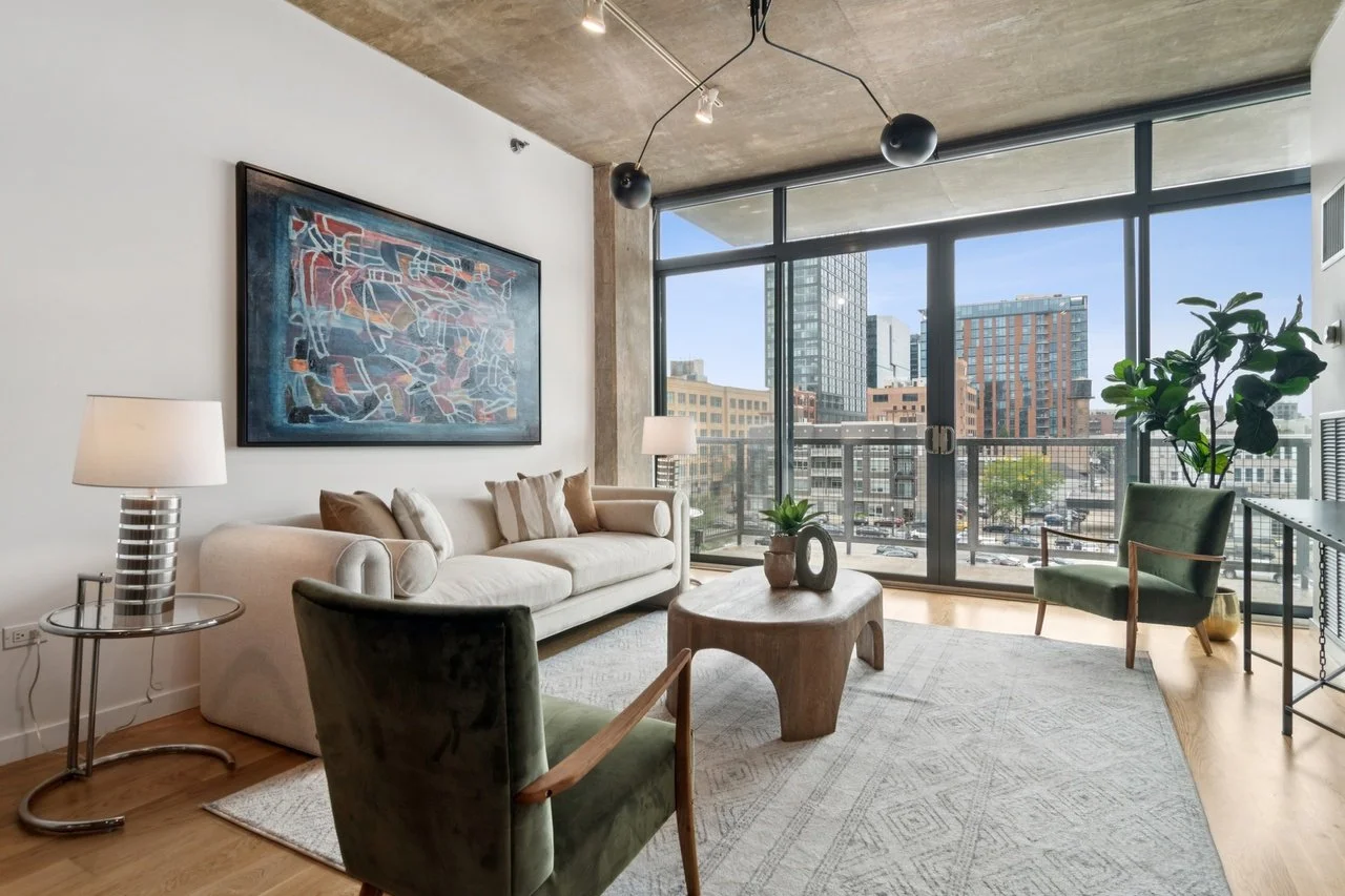 For this modern loft, our staging approach embraced the architecture while softening the space with layers of texture and warmth.

We paired contemporary furnishings with organic elements to:
&bull; Balance exposed concrete and brick with inviting te
