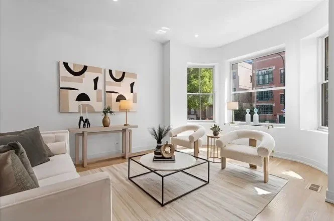 In this multi-level home, our staging approach centered on creating a natural sense of ease and cohesion from one space to the next. 

We chose crisp white backdrops and warm wood tones to establish continuity, then layered in textures, sculptural ac