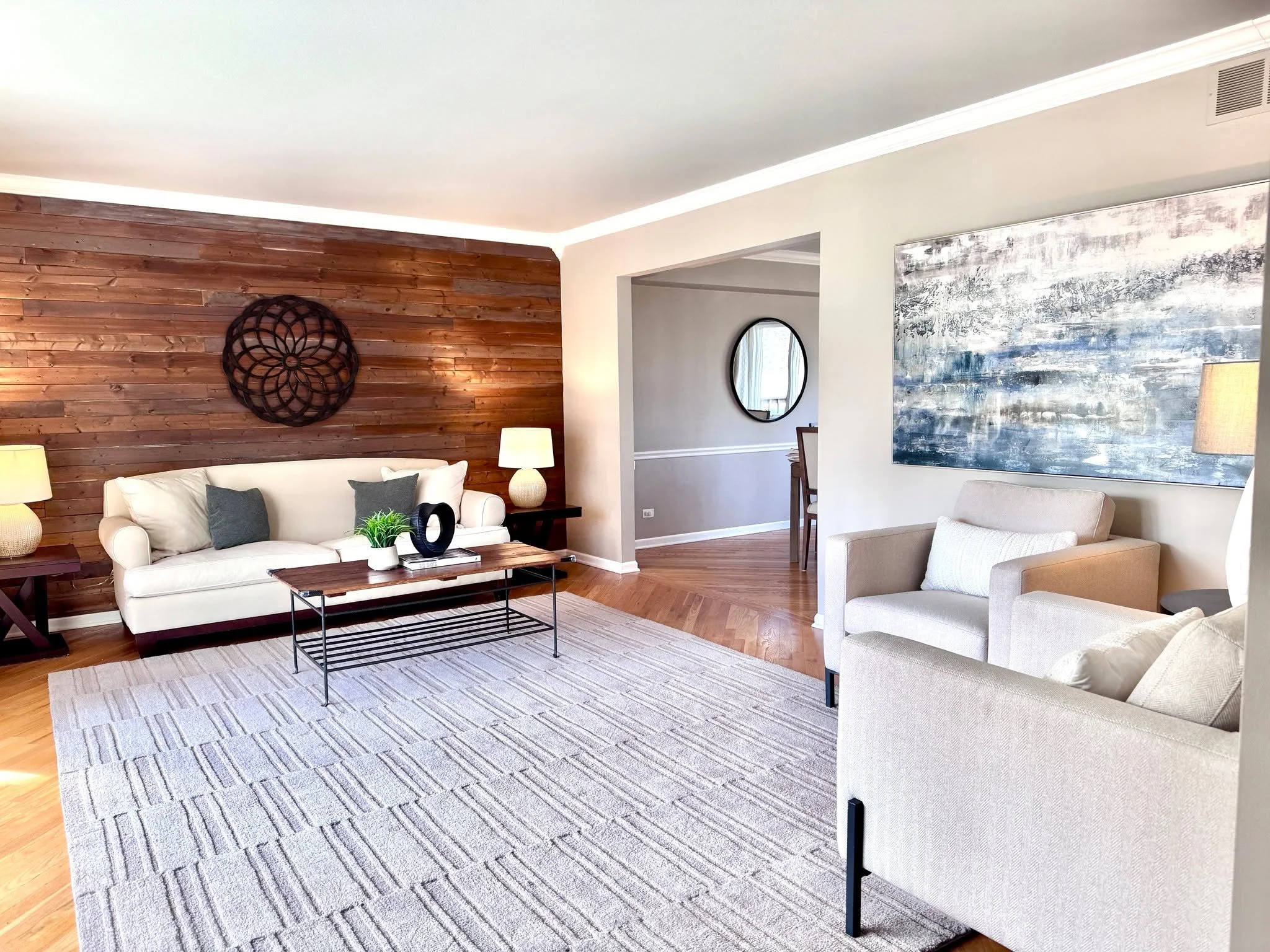 Not to be dramatic, but this is proof that one rug can, in fact, change the entire room.⁣
⁣
For this occupied listing, the goal wasn&rsquo;t to overhaul the space. It was to define and maximize it. A larger area rug established proper scale, a paired