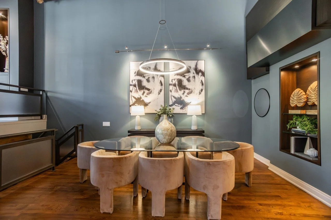 This triplex inside the old Nabisco factory already had the character West Loop buyers want: brick, timber, twenty-foot ceilings, and bones you can't manufacture. ⁣
⁣
Our role was to choose pieces bold enough to hold their own against the architectur