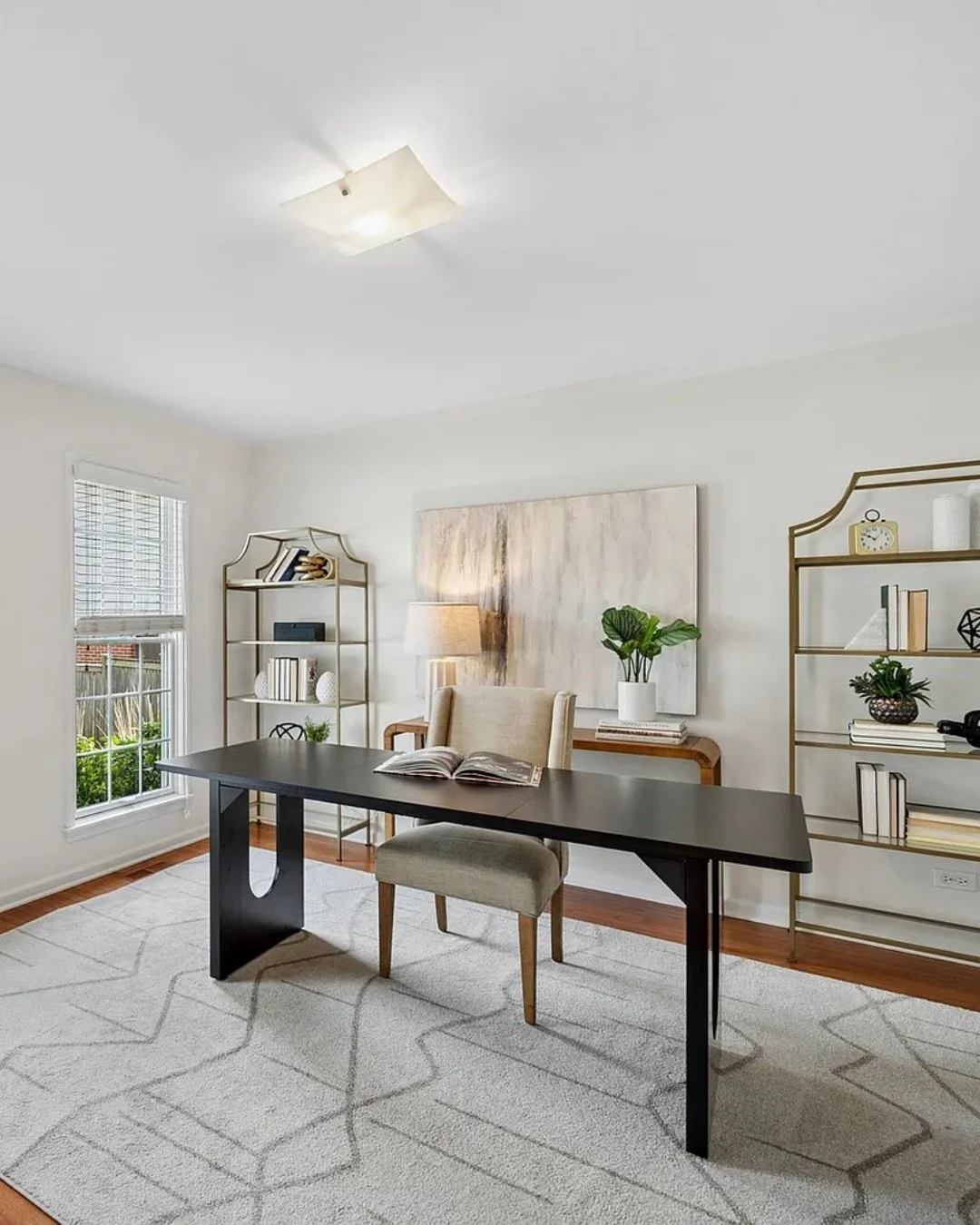 This Chestnut Manor row home offered something buyers in this market are always looking for: real flexibility. A main-floor bedroom off the entry had the potential to function as a private office, so that's exactly how we staged it. Paired with the e