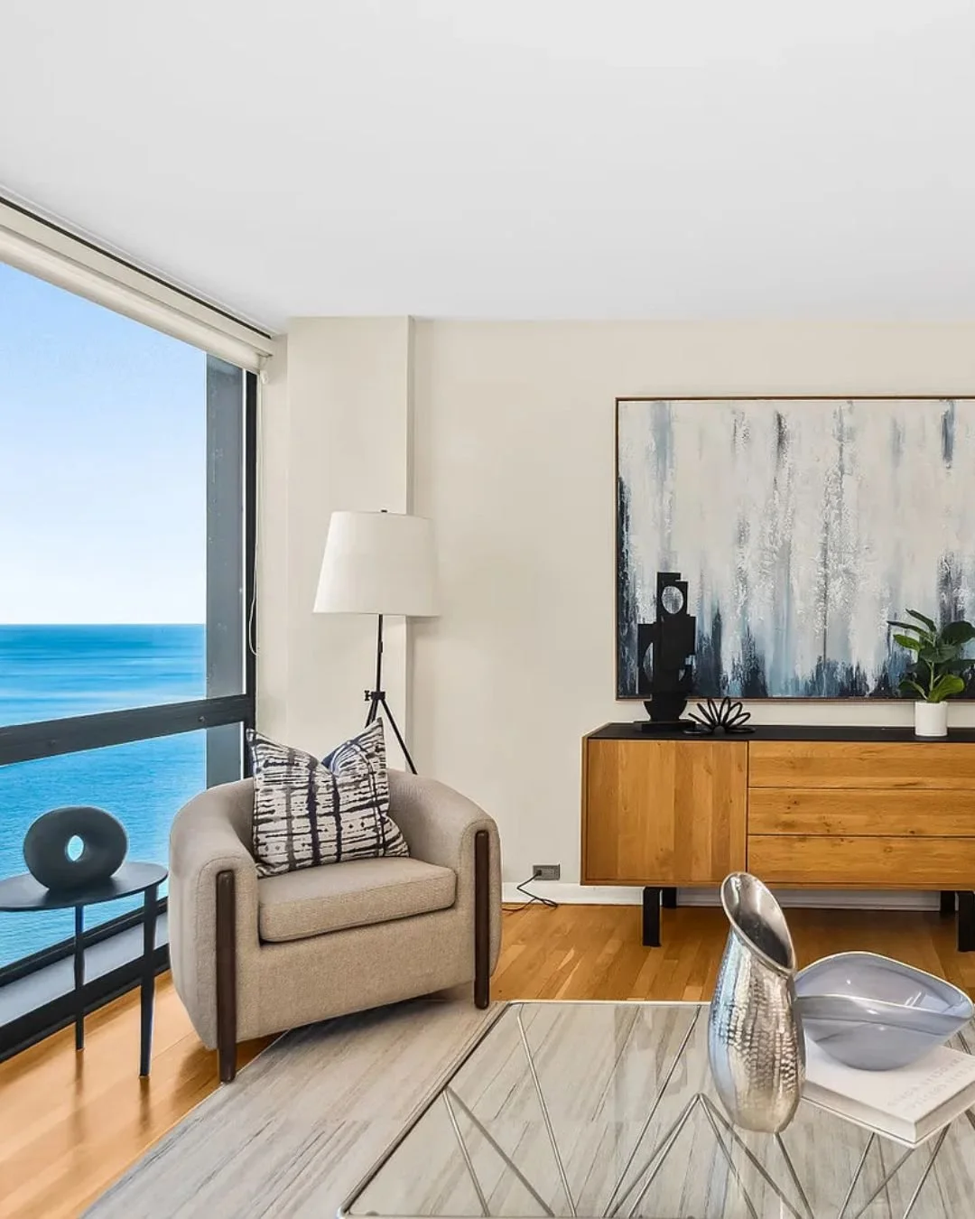 Staging a corner unit with panoramic views of Lake Michigan and Navy Pier meant our design couldn't compete with the view. It had to work with it. We leaned into clean lines that echoed the building's Mies van der Rohe architecture and styled the hom