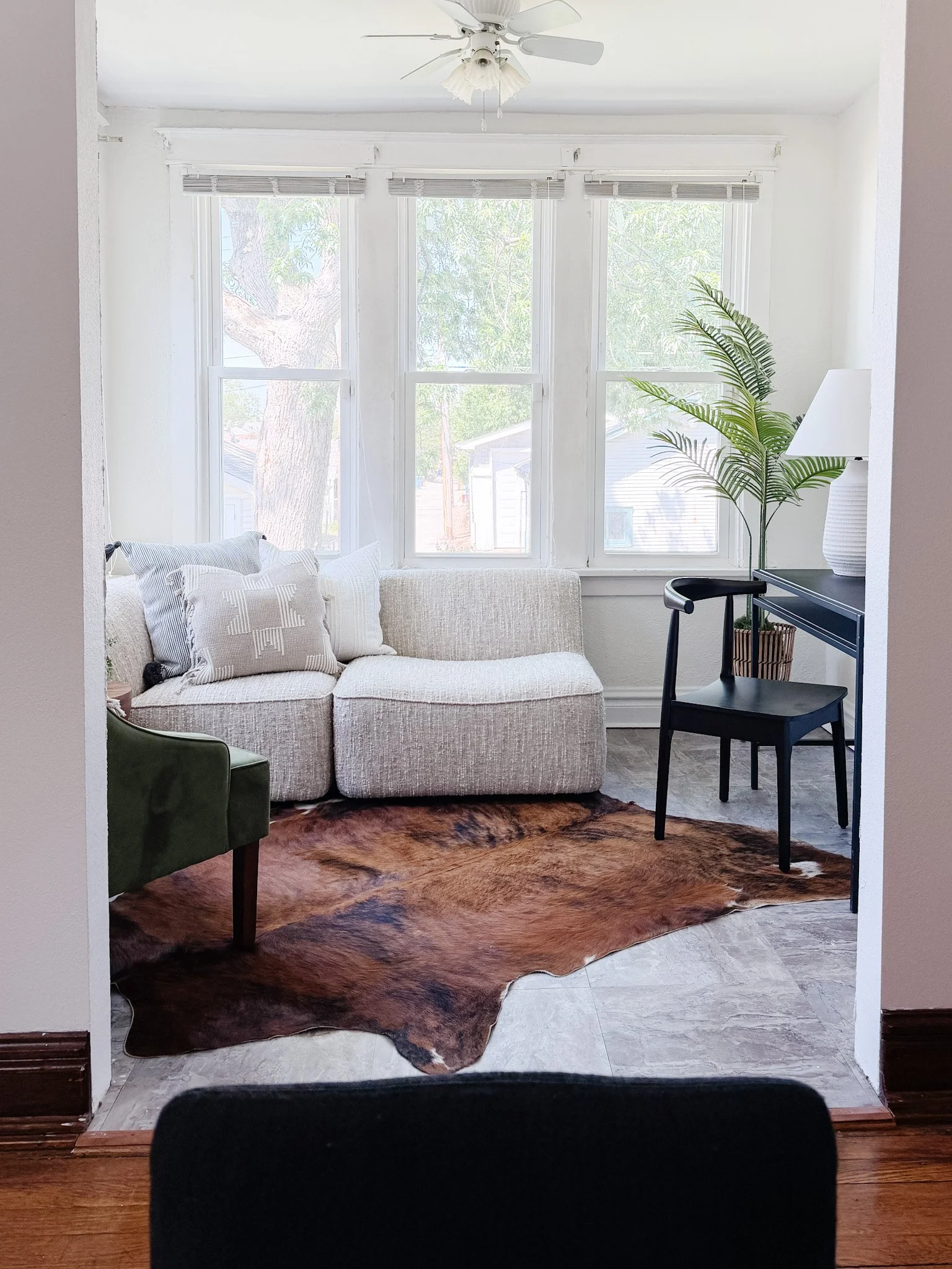 Under contract in 10 days. Holly Hills.

6011 S Grand Blvd came to us vacant. A long living room, a sunroom with no clear purpose, and a buyer pool skewing younger. We scaled the furniture to make the layout obvious, gave the sunroom a dual function 
