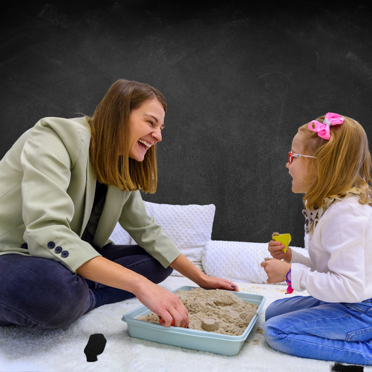 Therapist and child playing in sand tray