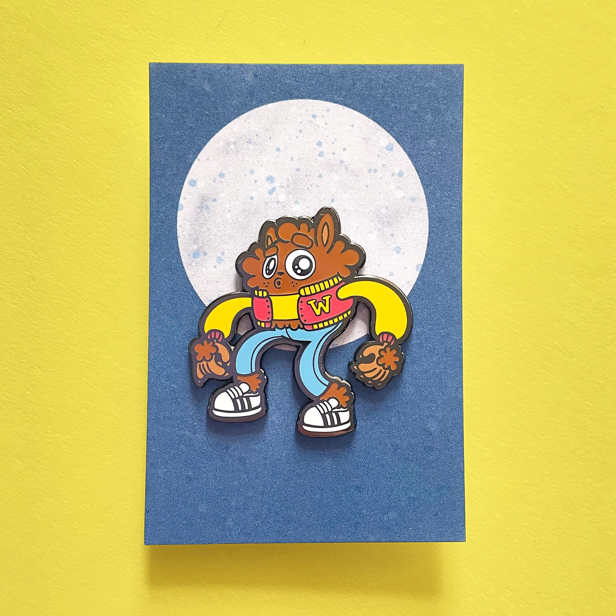 Photograph of the Teen Wolf enamel pin on a backing card.