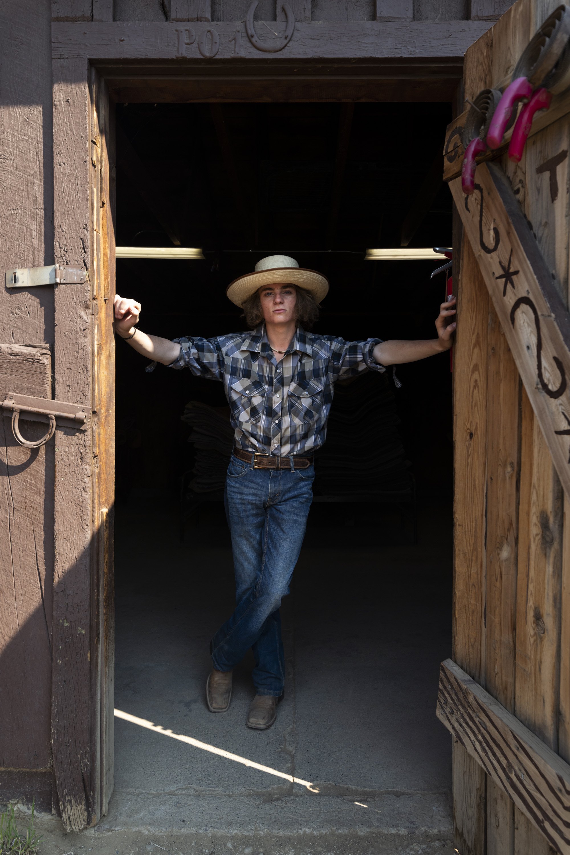  Patrick Smith poses for a portrait in the barn at Ponil on Philmont Scout Ranch on June 13, 2021. Smith works as a wrangler caring for the cattle that live on the ranch and teaching scouts how to ride horses and pack burros.  