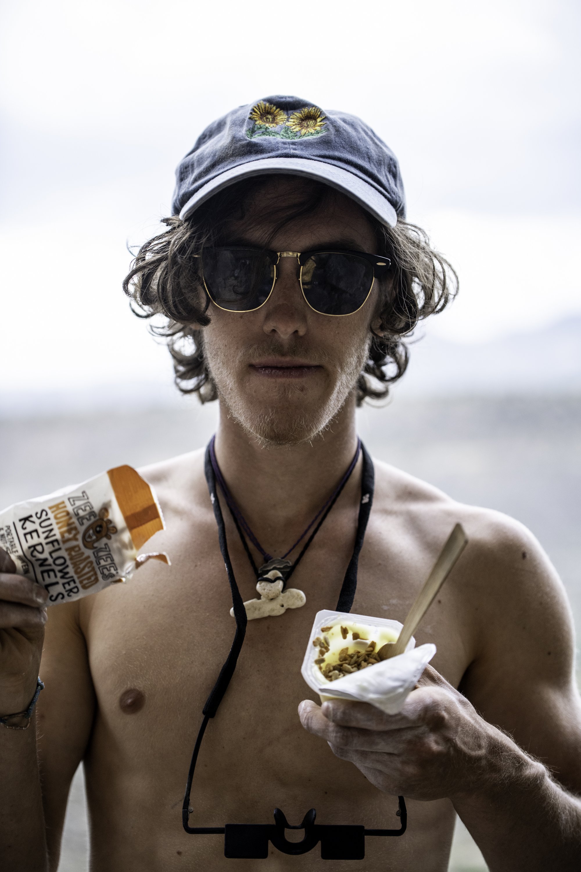  Kyle Higby pauses for a portrait while snacking on sunflower seeds and vanilla pudding while climbing in Taos, N.M. on June 17, 2022.  