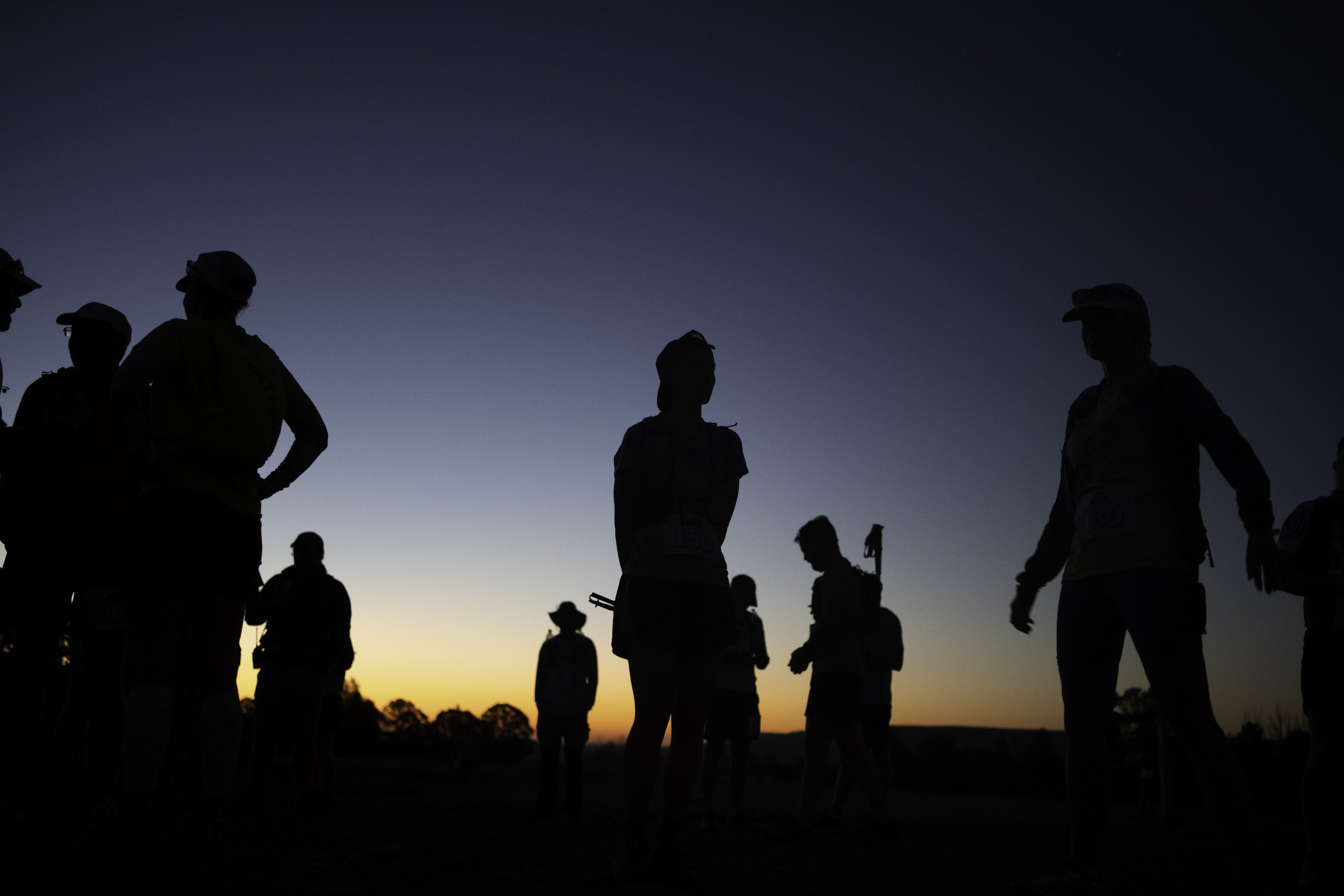  Racers stretch during sunrise before the marathon in the first annual Trail Race at Philmont Scout Ranch on Aug. 13, 2022, in Cimarron, N.M. Racers began their run at 7 am getting an early start before the mid-day heat.  