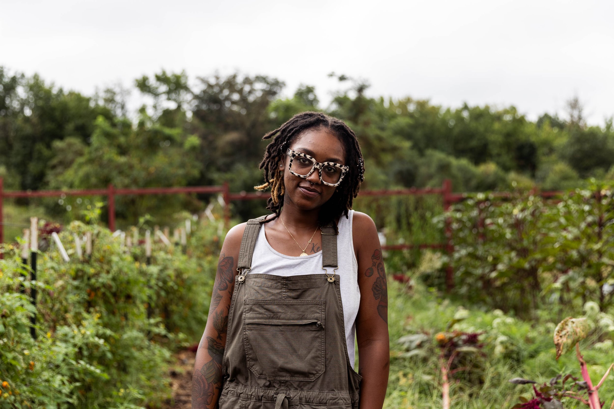  Saj Dillard poses for a portrait in the grow space at BLISS Meadows in Baltimore, Md. on Sept. 11, 2023. Dillard is the farm manager at Backyard Basecamp. 