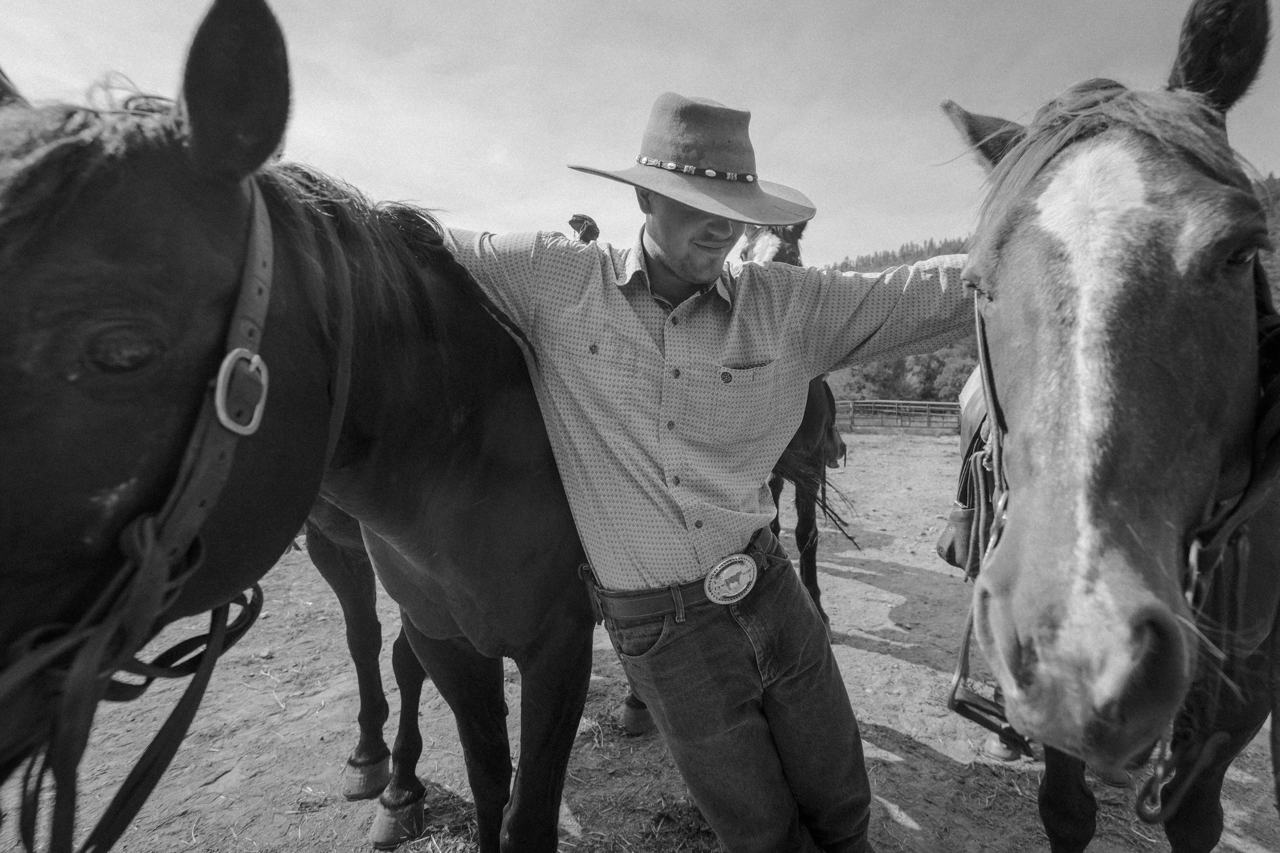  Alex McLendon embraces two horses at Ponil on Philmont Scout Ranch, N.M. on June 13, 2021. McLendon worked as a wrangler for the summer season on the ranch helping to take care of horses and burros.   
