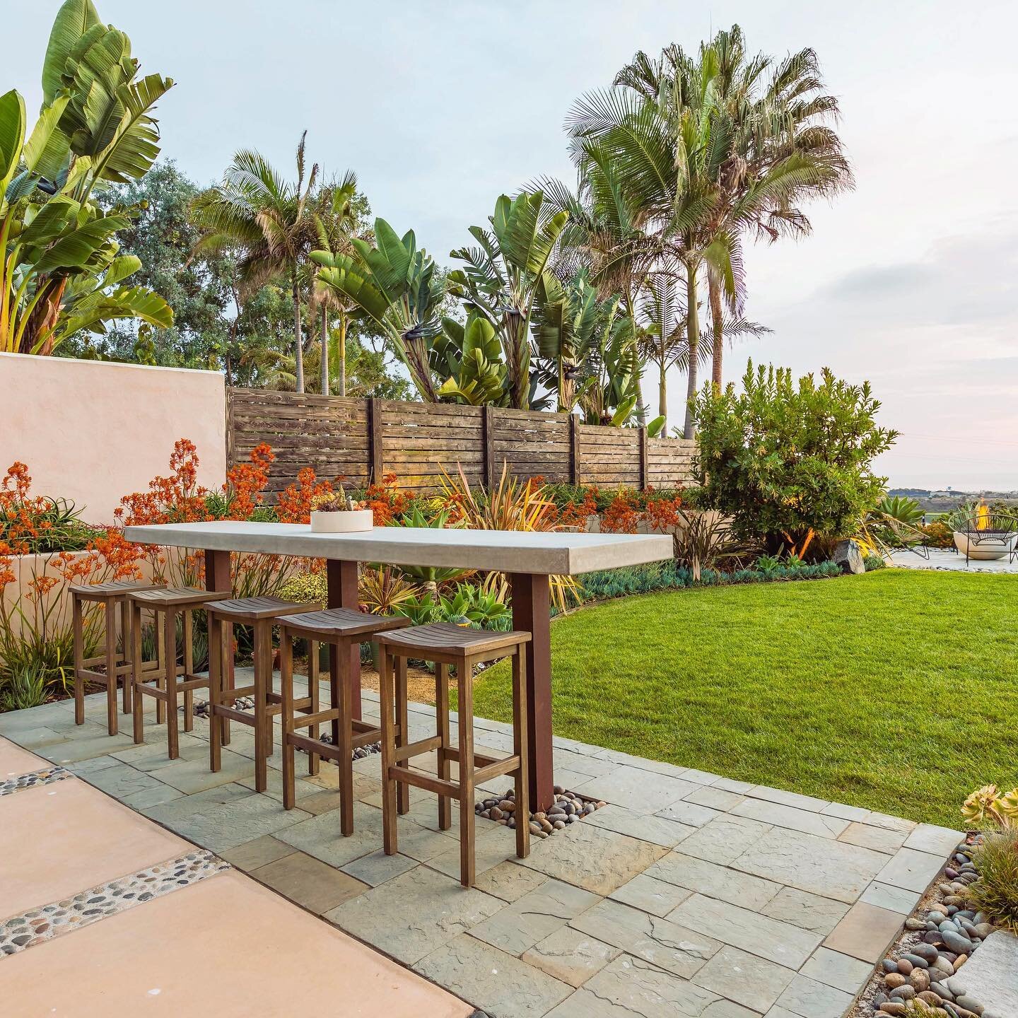 These are the best seats in the house. This yard sits above the Batiquitos lagoon  in Leucadia and looks out over Ponto beach. We cut into this existing slate patio and placed Corten steel posts to support an open floating bar top to sip cocktails as