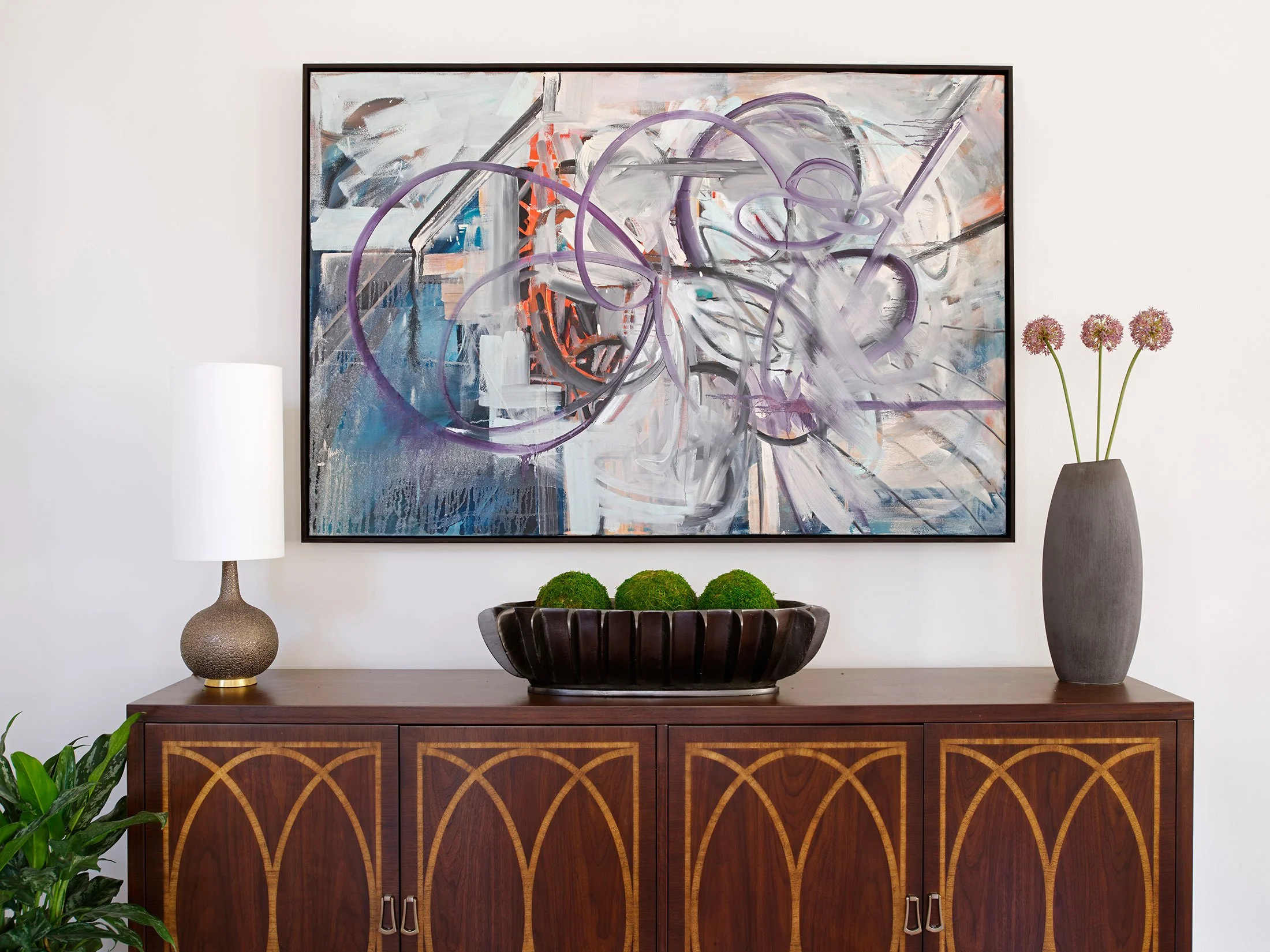 Contemporary abstract painting in the dining area over the buffet