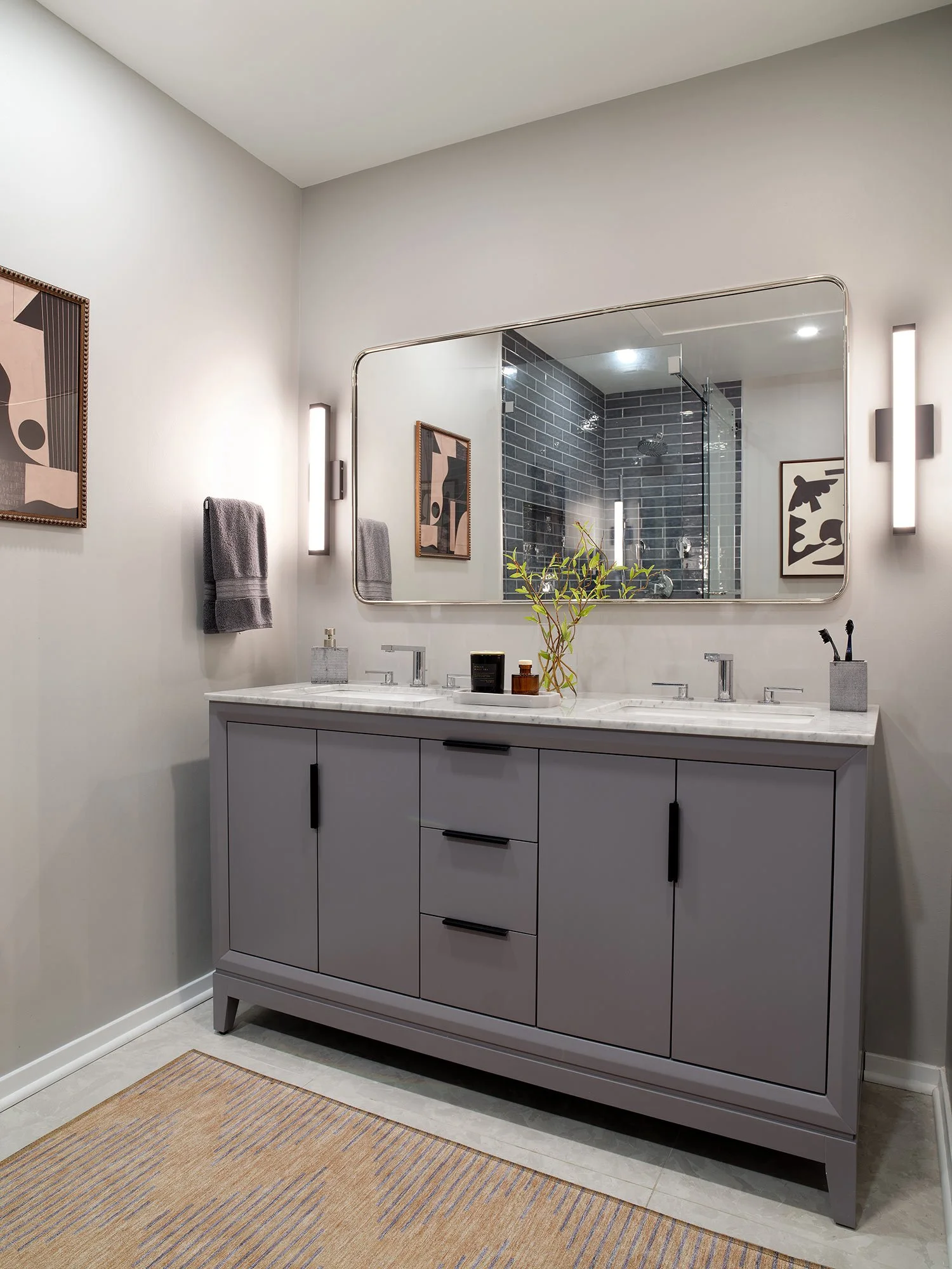 Modernist print by the vanity in the primary bathroom