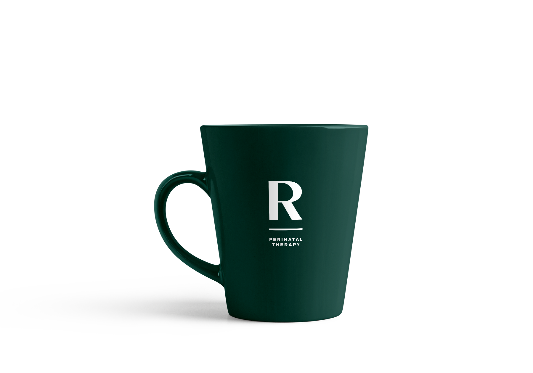 Dark green ceramic mug with white letter 'R' and words 'Perinatal Therapy' on it, with a matching smaller cup behind it, both casting shadows on a white background.