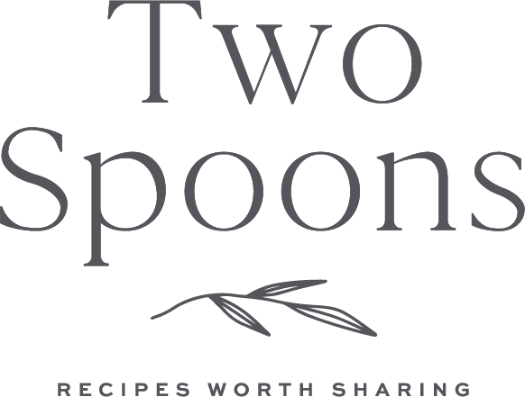Text with the phrase 'Two Spoons' and a subtitle 'Recipes Worth Sharing' in black on a dark background, featuring a minimalist illustration of a spoon and leaves.