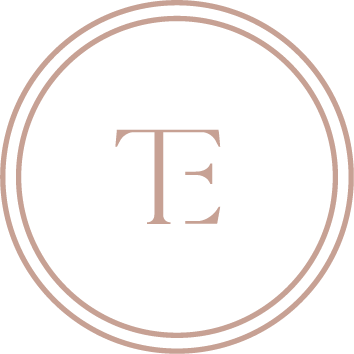 A circular logo with a double outline and the letter 'T' in the center.