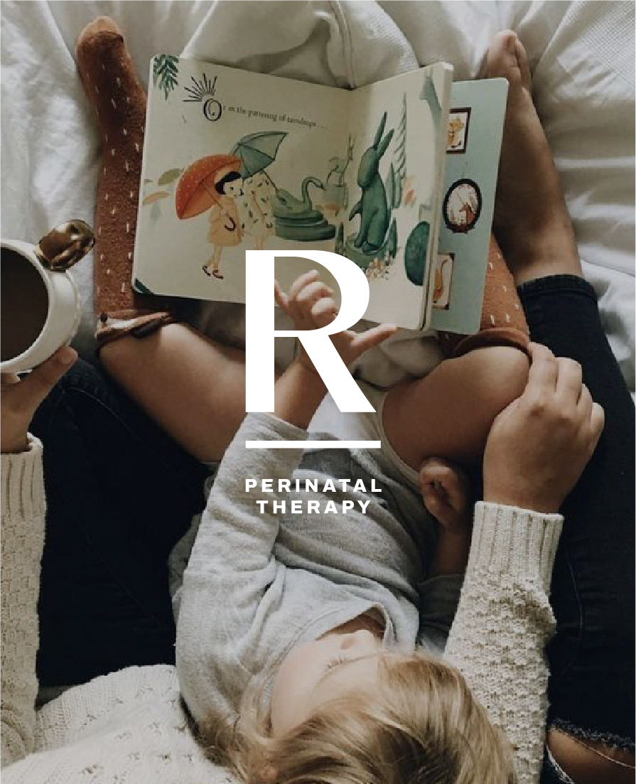 A woman with a child lying on her lap and a dog on her lap, reading a children's book about dinosaurs while holding a coffee mug and a breadstick.
